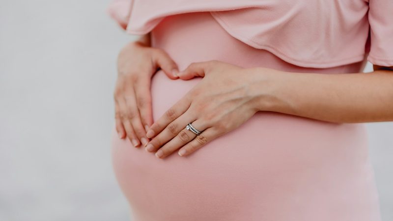 A pregnant woman holding her belly